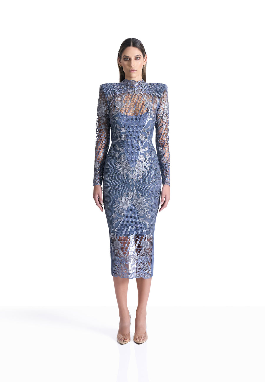 Woman wearing a blue lace dress on a white background